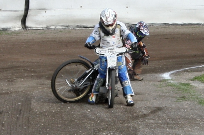 Jaroslav Vaníček v rozjezdu za sebou vleče zaháknutý motocykl Daniela Klimy, který upadl